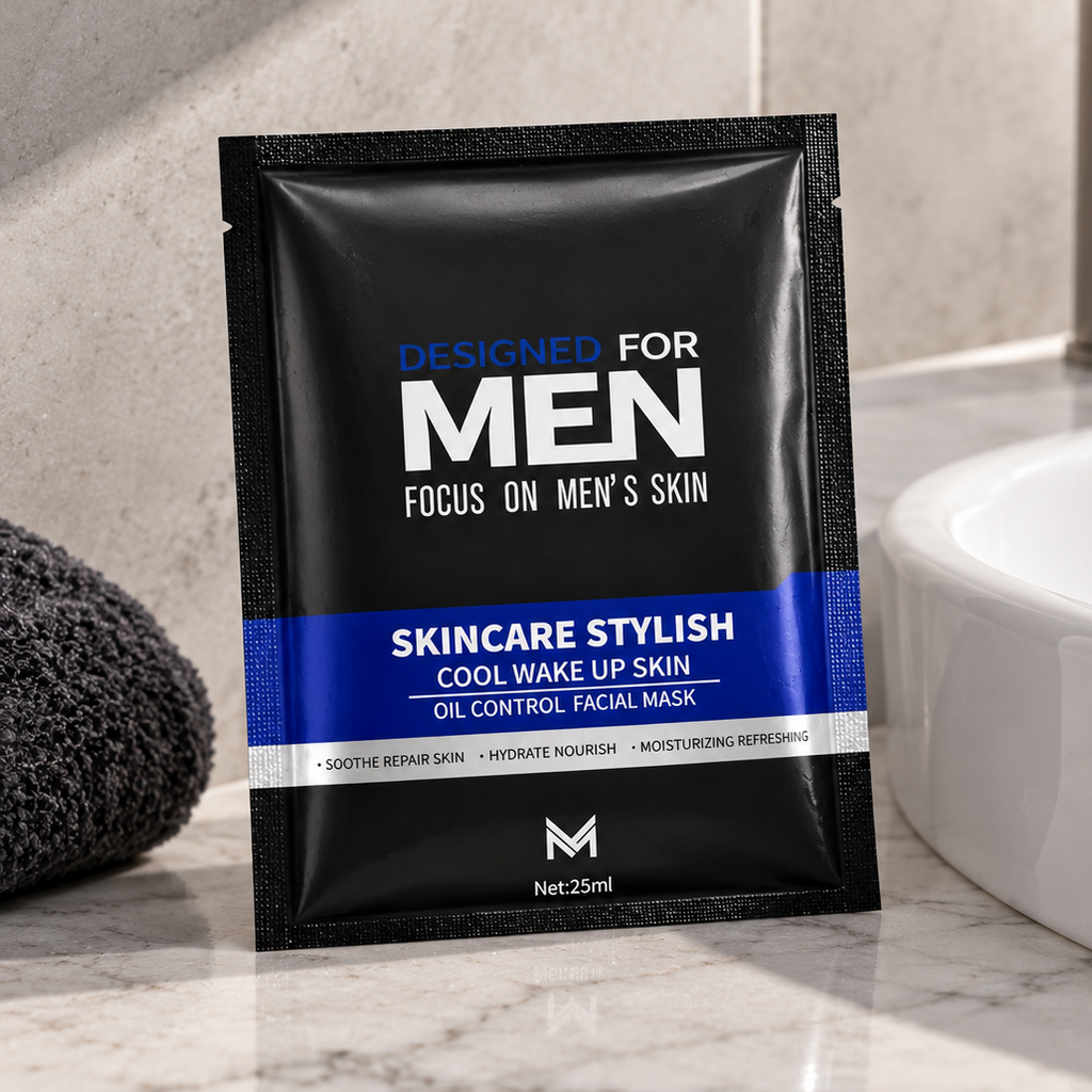 A single black and blue sachet of Men's Skincare Stylish Cool Wake Up Skin oil control facial mask is placed on a marble countertop next to a white sink and a dark gray towel.
