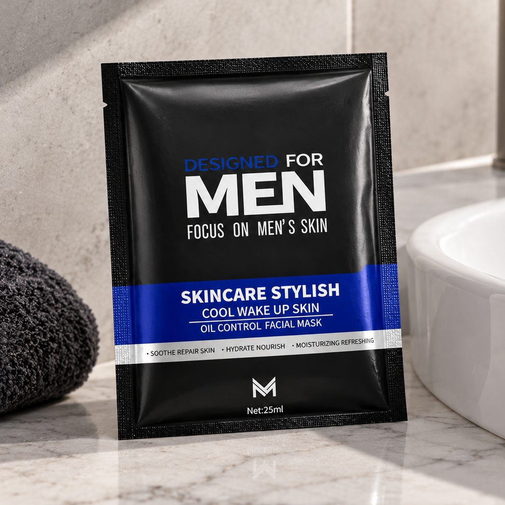 A single black and blue sachet of Men's Skincare Stylish Cool Wake Up Skin oil control facial mask is placed on a marble countertop next to a white sink and a dark gray towel.