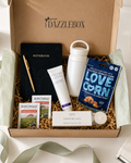 Employee onboarding gift box contents laid out on a white background