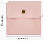 Pink faux leather envelope-style card holder or coin pouch with a gold snap button, shown both flat with dimensions labeled 8CM/3.15in and being held in a hand.